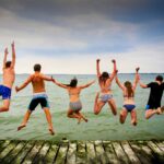 Bennu Chardonnay people jumping off a dock into a lake
