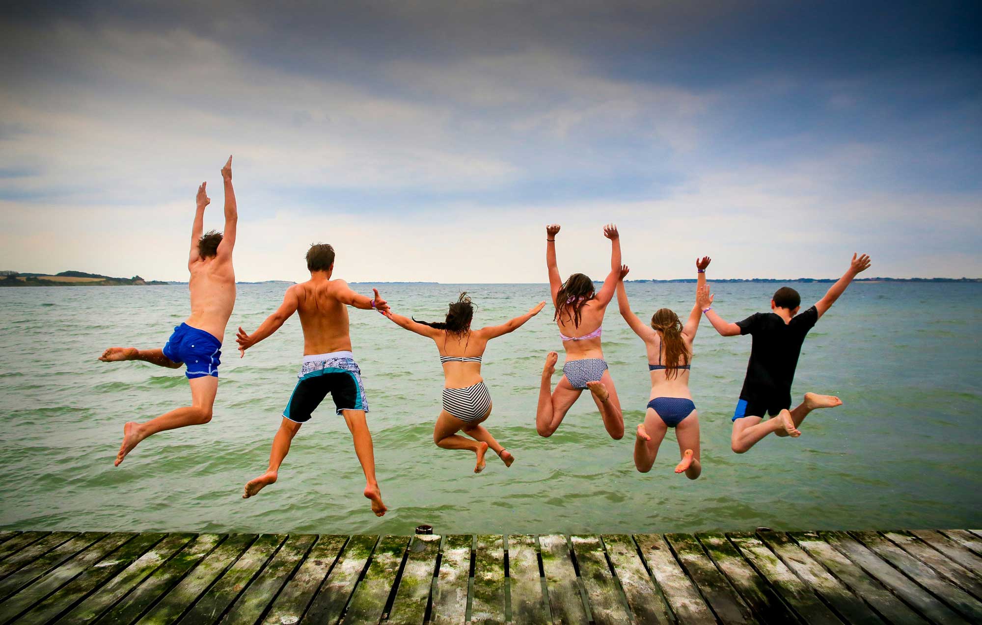 Bennu Chardonnay people jumping off a dock into a lake