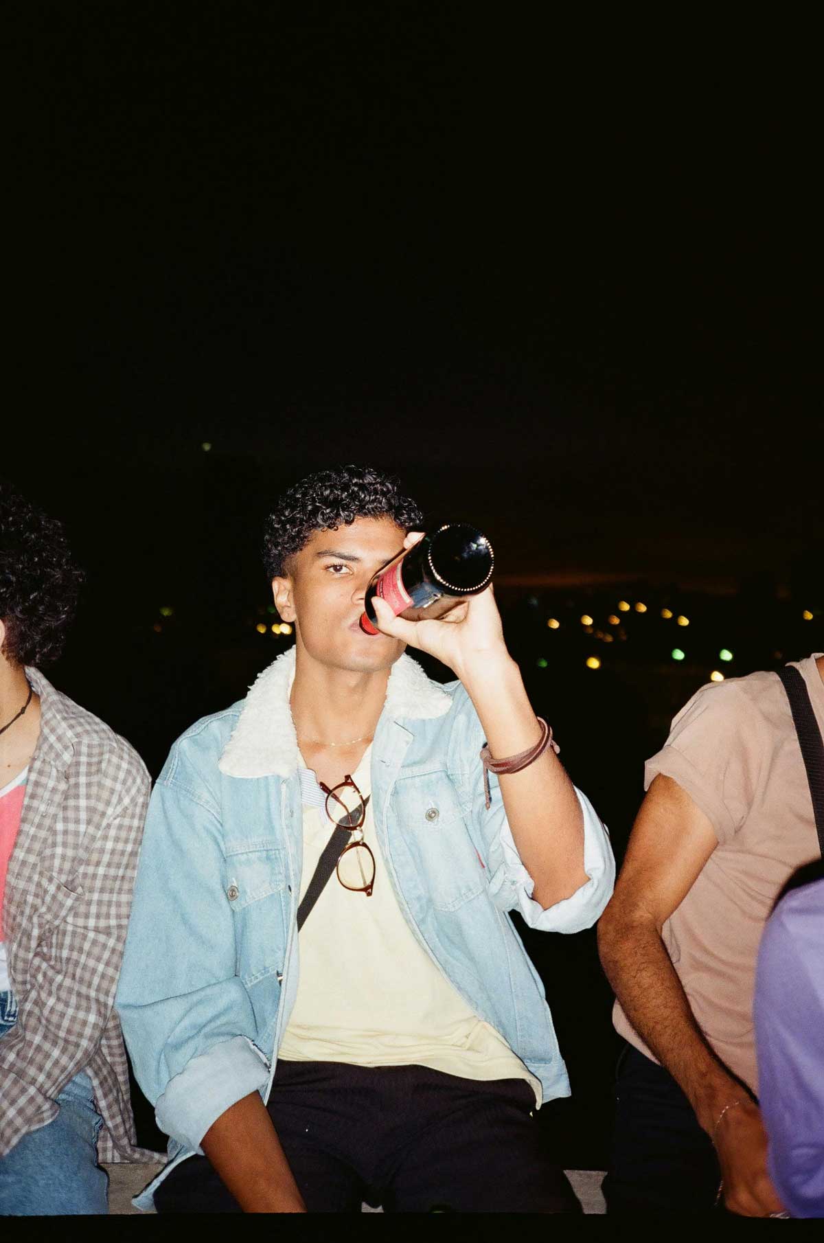 Man drinking red wine from a bottle